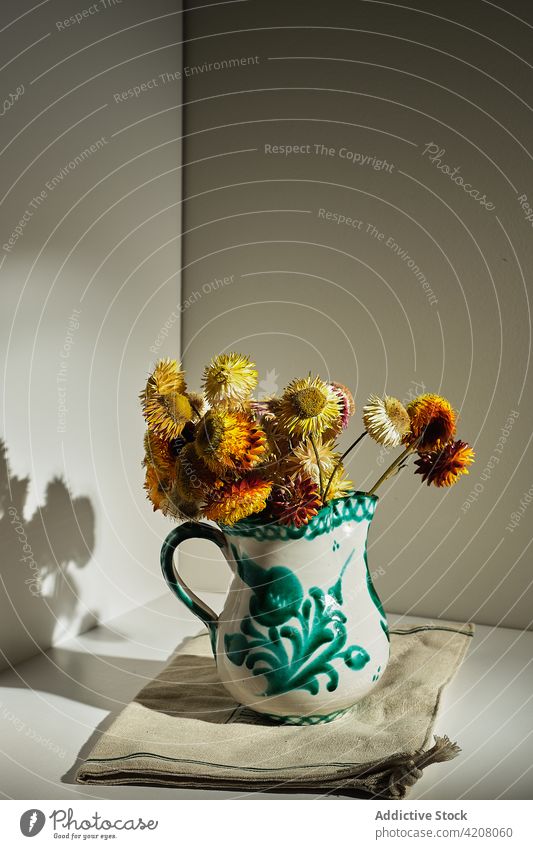 Strawflowers in ceramic jug on table bouquet bunch strawflower pitcher floral bloom fresh sunlight natural decor home organic composition vase fragrant design