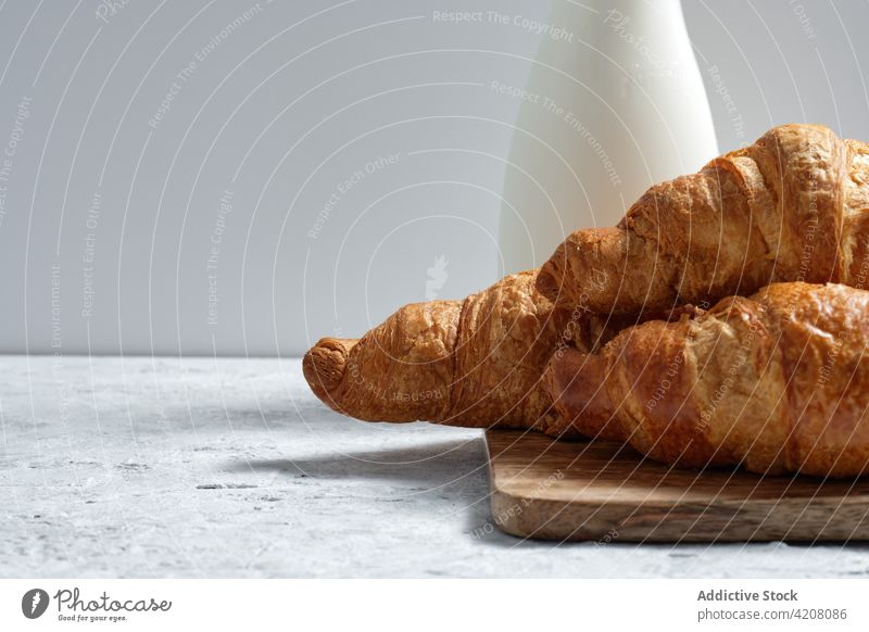 Tasty croissants on table at home milk breakfast kitchen tasty morning fresh baked meal food dairy beverage pastry bottle delicious drink dessert appetizing