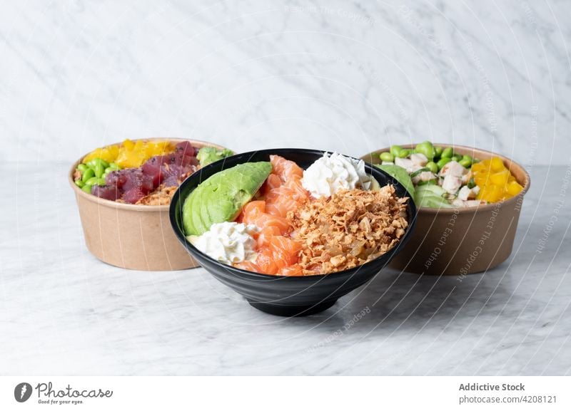 Bowls with poke dish served on table bowl fish food tasty appetizing homemade fresh ingredient nutrition yummy cuisine meal kitchen assorted marble delectable
