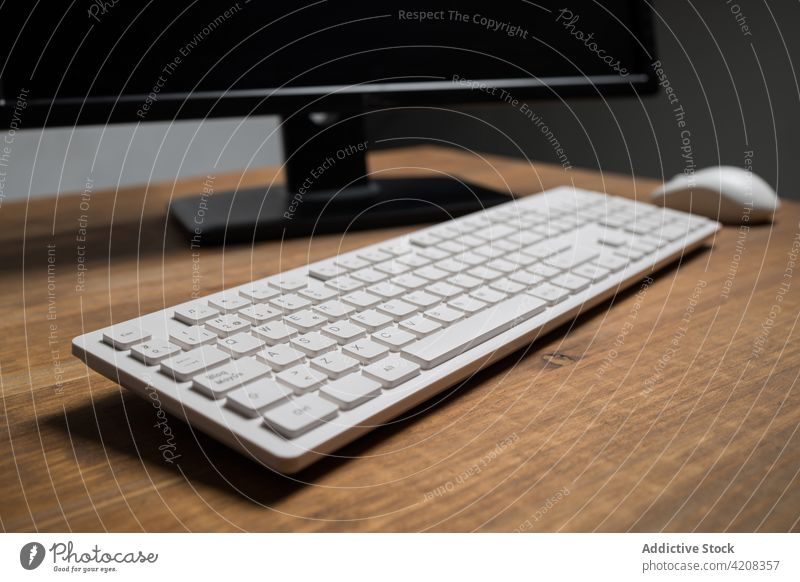 Keyboard with mouse arranged on desk keyboard monitor computer office workplace electronic job digital decoration technology modern wooden table workspace