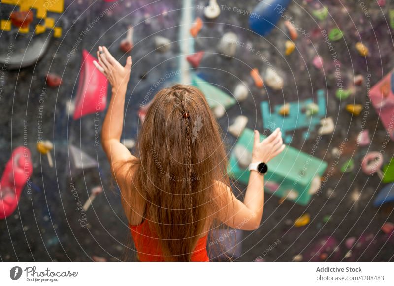 Sportswoman standing near climbing wall in gym sportswoman mountaineer climber confident fit fitness healthy athlete vitality energy charming strong bouldering