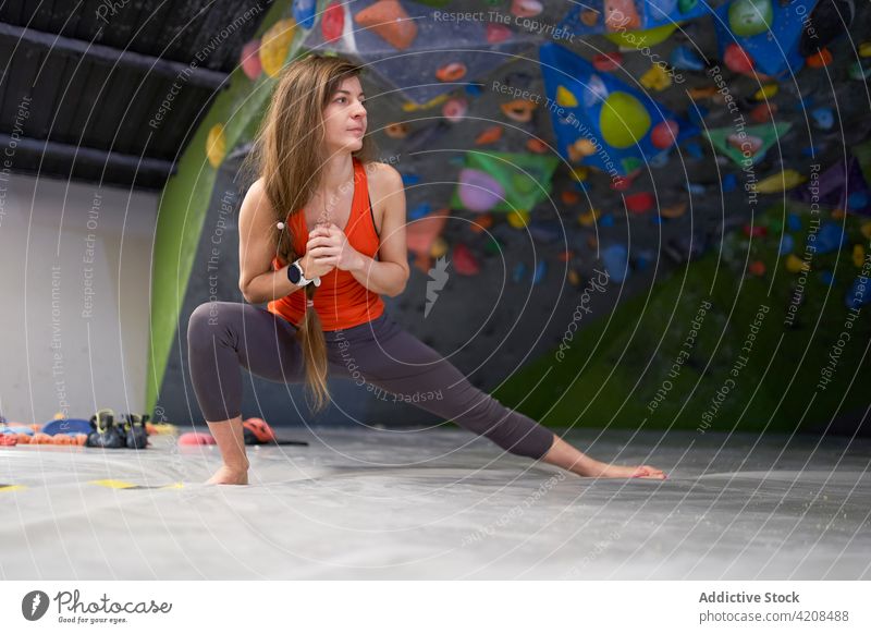 Active woman stretching legs before training bouldering mountaineer active focus warm up sporty climber female strong determine concentrate healthy athlete