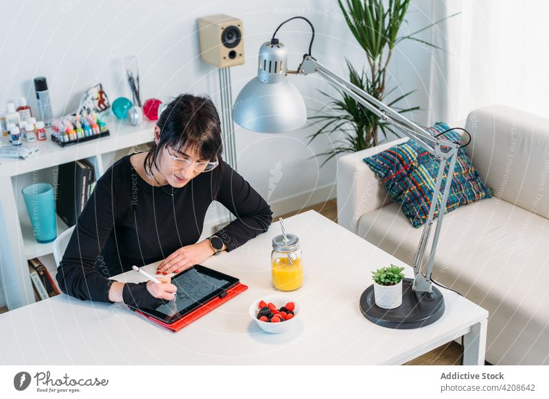 Woman drawing on tablet at home woman designer artist create artwork digital illustrator female job creative project gadget device using focus busy occupation