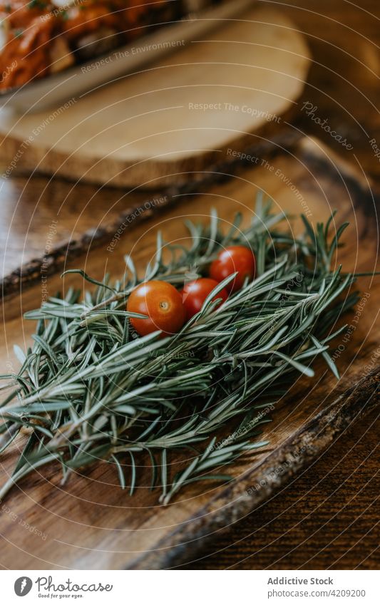 Fresh cherry tomatoes with aromatic rosemary sprigs healthy food vegetable herb natural organic ingredient plate rustic style nutrient fresh ripe whole vegan