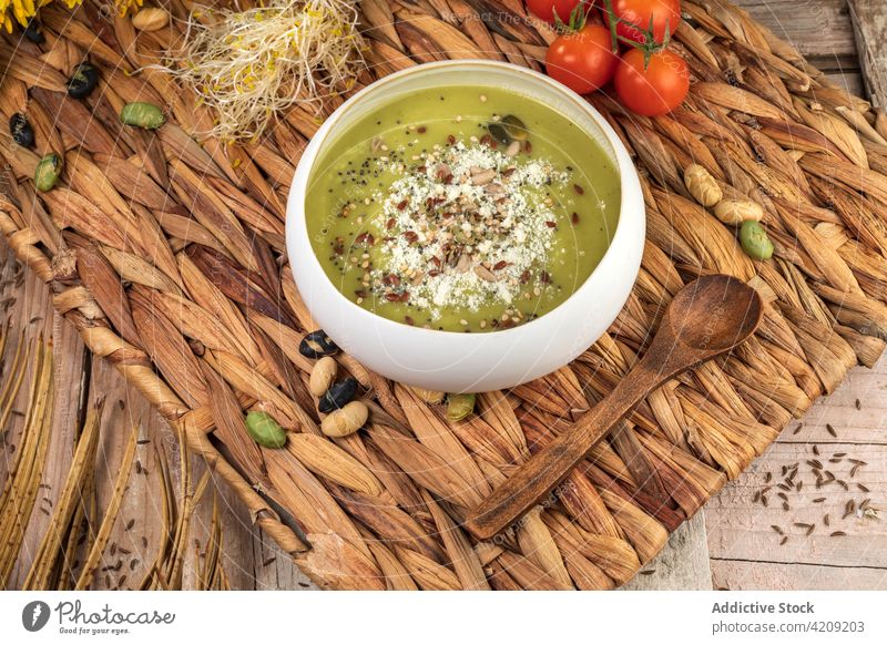 Delicious vegetarian puree soup with pistachios in bowl healthy food dinner lunch meal natural appetizing product ingredient vitamin protein whole crushed spoon