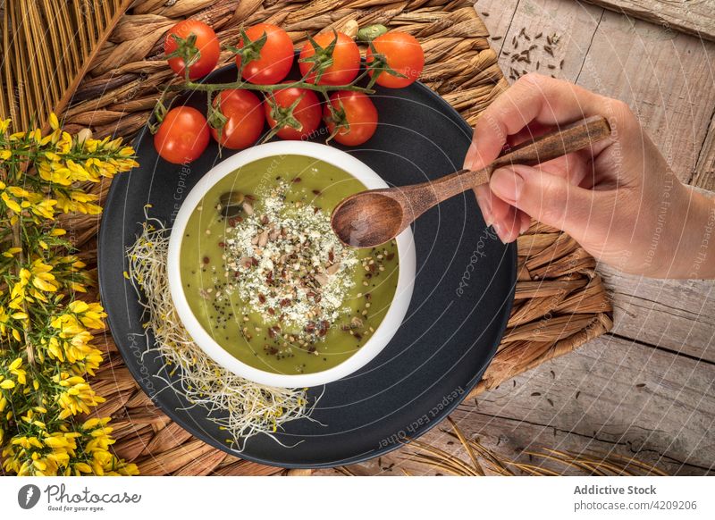Crop cook with tasty vegan puree soup and spoon chef pistachio cream vegetarian healthy food dinner lunch eco bowl meal delicious spice wooden sprout