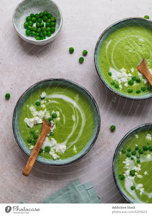 Tasty pea soup in bowls on table cream green delicious serve dish fresh organic tasty food meal gourmet healthy healthy food vegetarian vegan napkin puree