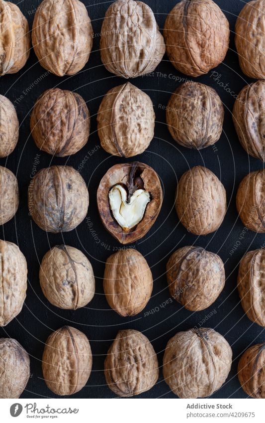 Textured background of dry walnuts in rows distinct unique uncommon exceptional snack unpeeled natural heart love product organic vitamin protein texture