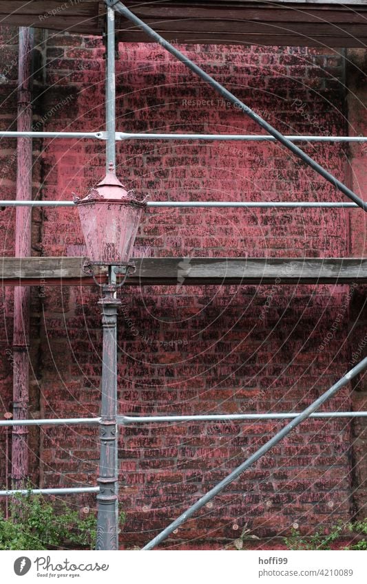 red paint splashes on lantern, scaffolding and wall Red speckled Smeared Vandalism destructive rage Protest protest action Wall (barrier) Street lighting Facade