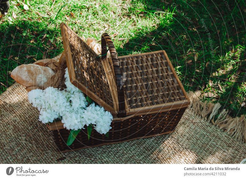 Picnic basket with flowers and breads background bouquet camping closeup copy space countryside food green leisure natural nature nobody outdoors outside park