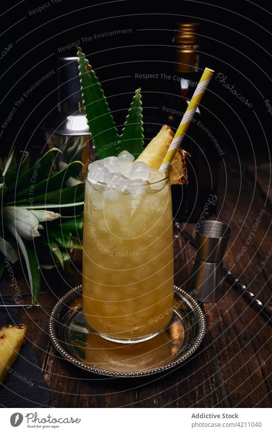 Tray with cocktail decorated with pineapple near bottle and shaker glass straw bar tray table alcohol vegetarian mix restaurant booze leaf refreshment tasty