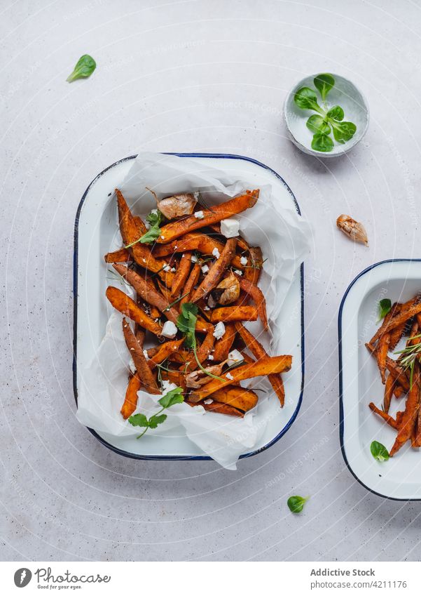 Sweet potato fries in bowl on table sweet baked crispy serve herb tasty food snack appetizing appetizer sour cream meal yummy portion delicious palatable