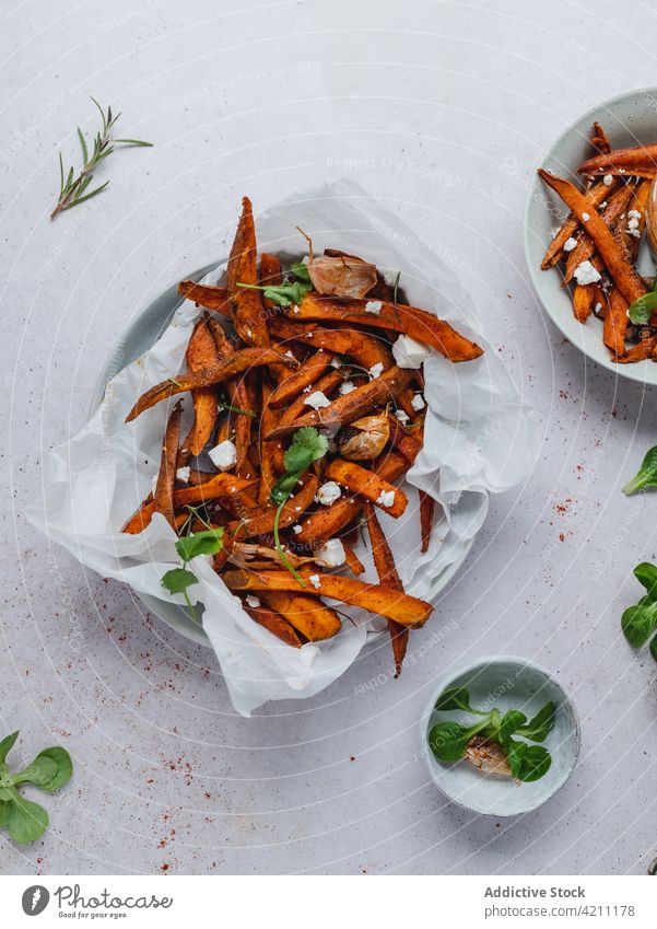 Sweet potato fries in bowl on table sweet baked crispy serve herb tasty food snack appetizing appetizer sour cream meal yummy portion delicious palatable