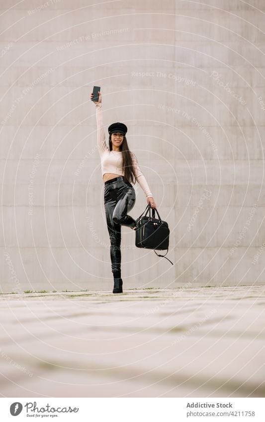 Carefree stylish businesswoman standing on street carefree cheerful city having fun style trendy entrepreneur smile female smartphone gadget happy connection