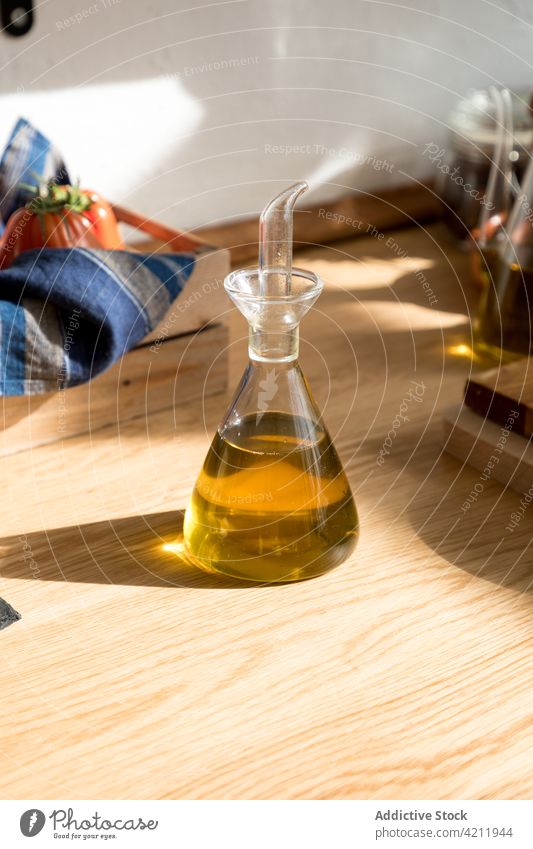 Olive oil in glass jar on table olive kitchen natural food ingredient aromatic culinary healthy cuisine organic wooden cook meal gastronomy product bottle