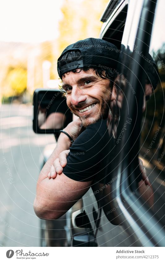 Happy off-road vehicle driver leaning out of the window man transportation portrait car outdoors driving smiling journey emotion happiness looking male happy