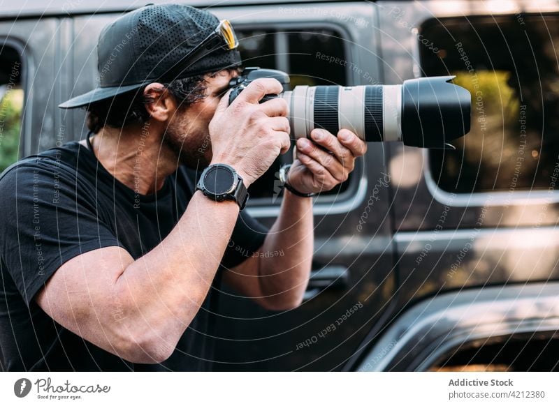 Adventurous photographer taking photos with his off-road car man adventure camera people photography adult lifestyles nature outdoors exploration transportation