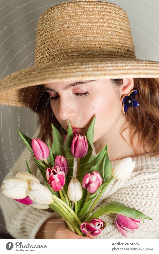 Tender woman with flowers in studio tender tulip dreamy gentle floral spring romantic female dress delicate feminine natural calm fresh eyes closed young
