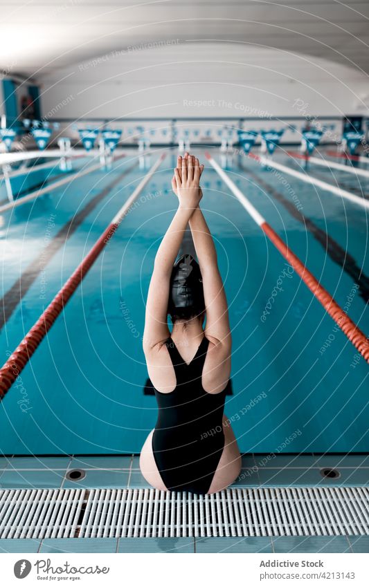 Swimmer sitting on the edge of the pool sport water swimmer female woman athlete young swimwear training blue people cap competition person lifestyle healthy