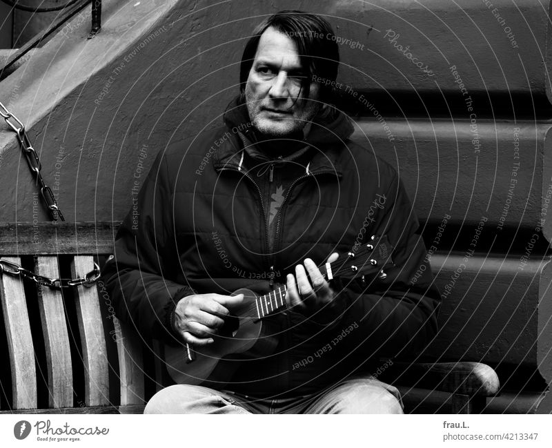 A man with a ukulele Man Face portrait Winter Bench bench seriously concentrated Ukulele Artist Musician corona For willma: the bench at baker Willi's.