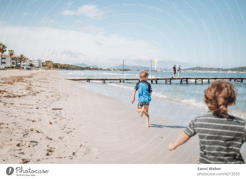 running children at the beach of Port de Alcudia Beach Ocean Sand Water Nature Sun Waves Sky Vacation & Travel Beautiful weather Exterior shot Relaxation