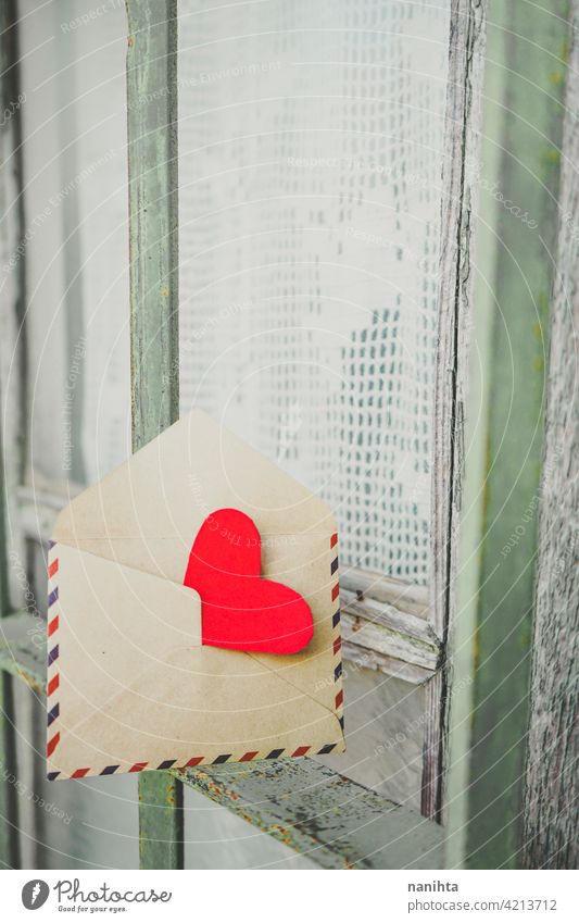 Red heart inside an old envelope red window love cover nostalgia mail retro vintage romantic card background valentine valentine's day romance fence curtains