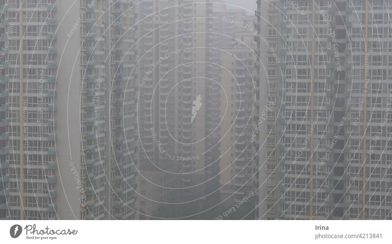 Chinese skyscrapers in the dense smog in Beijing. Smog Air pollution China City of millions block of flats High-rise Architecture Overpopulated cramping uniform
