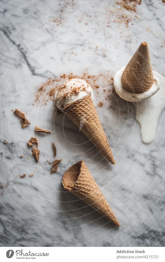 Delicious ice cream cones with cinnamon powder dessert treat sweet waffle meringue milk yummy tasty scoop gelato portion crunchy delicious table marble material