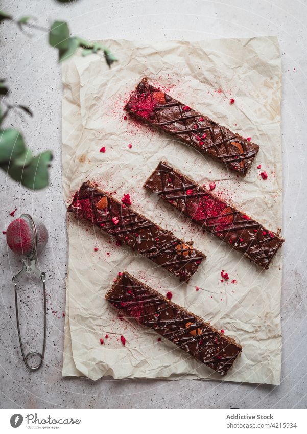 Several chocolate bars with raspberry on a table dessert sweet food snack cocoa tasty brown delicious isolated candy piece dark cacao milk calorie ingredient