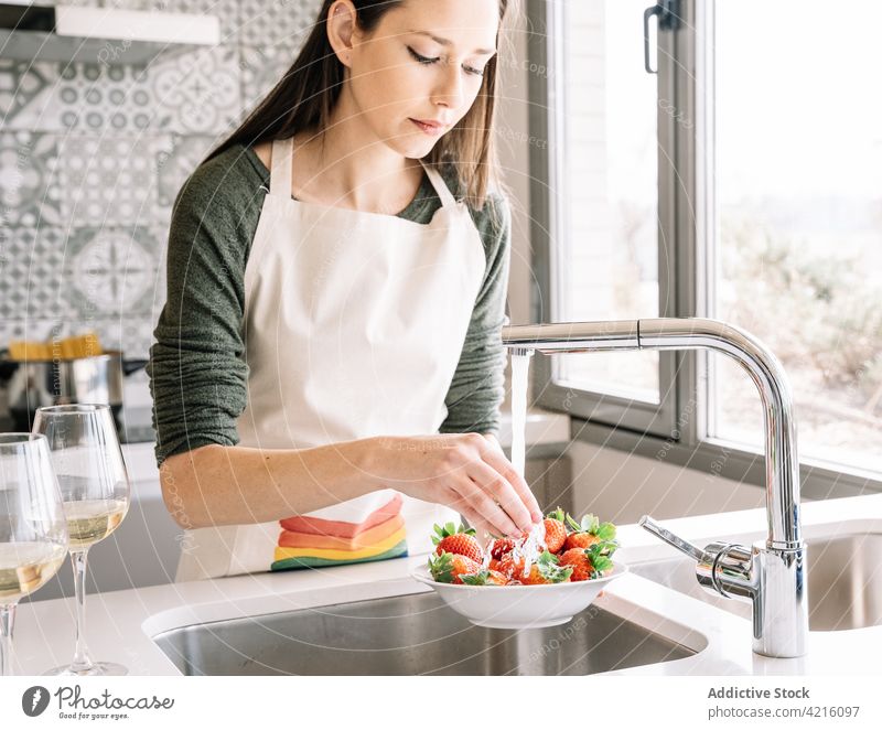 Crop woman washing strawberries under water flow at home strawberry tap vitamin delicious natural kitchen portrait pour healthy food process sink window wine