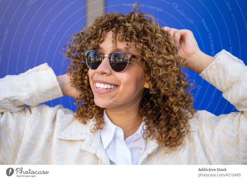 Cheerful black woman with curly hair cheerful carefree delight afro hairstyle studio happy female ethnic african american charming sunglasses joy glad trendy