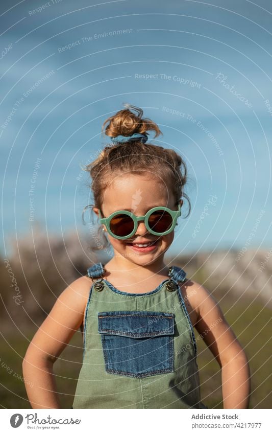 Carefree child standing in field in countryside girl carefree freedom summer enjoy happy kid smile adorable cheerful meadow childhood nature cute having fun