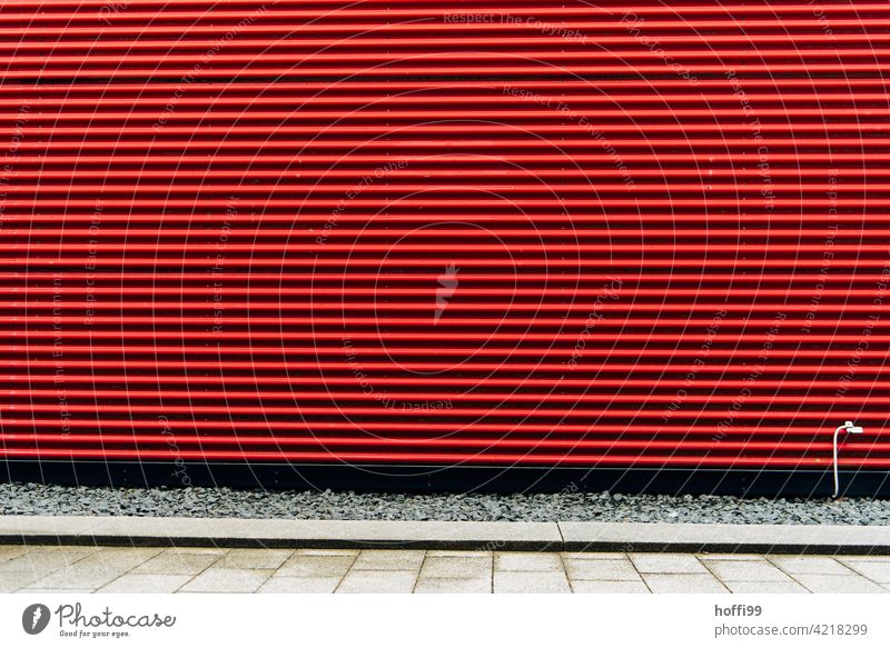 red corrugated metal facade with grounding cable Corrugated iron wall urban with red stripes Striped Minimalistic Red Facade Corrugated sheet iron