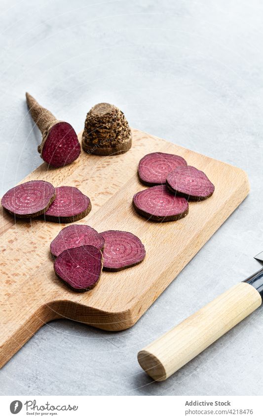 Beetroot slices on knife arranged on cutting board beetroot vegetable cook composition raw process appetizing ripe ingredient recipe organic product nutrition