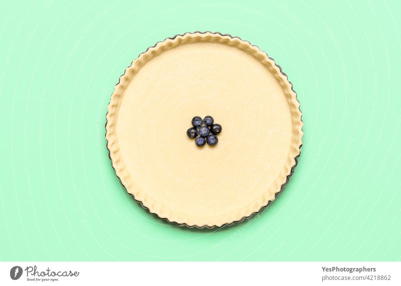 Pie crust and blueberries in a tray, top view. Baking blueberry pie with pastry dough 4th july above view american bake bakery baking bilberries