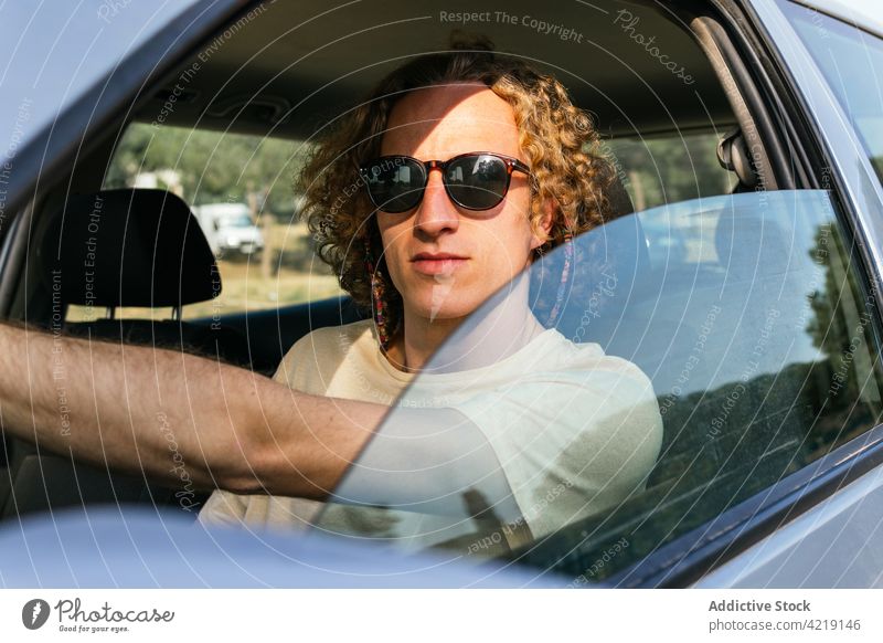 Man in sunglasses driving car man drive style automobile window confident trendy male young serious driver vehicle eyeglasses eyewear hair lifestyle transport