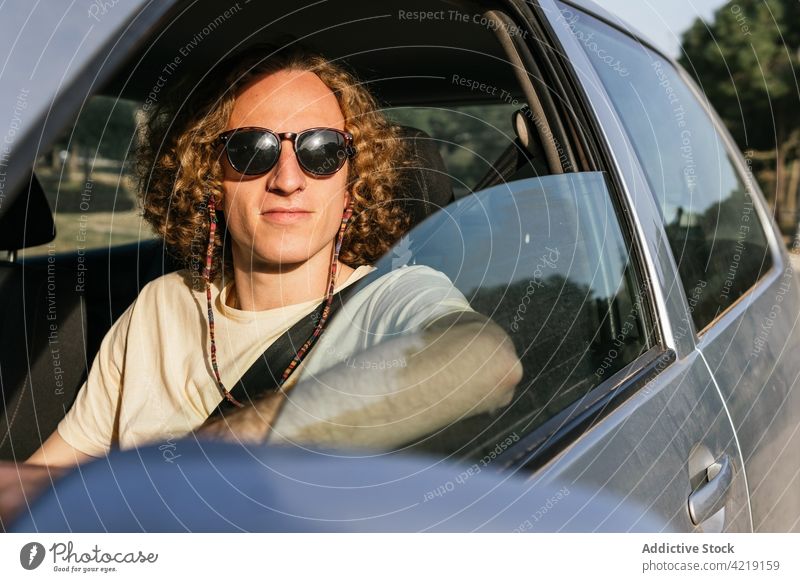 Man in sunglasses driving car - a Royalty Free Stock Photo from Photocase