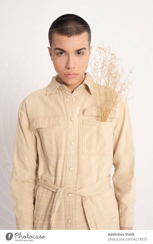 Stylish man with dried plants in studio androgynous model style fashion feminine bunch male appearance individuality trendy outfit vogue personality tender