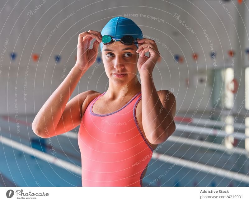 Sportswoman in swimsuit and goggles against swimming pool swimmer sport attentive swimwear wellness vitality portrait body sportswoman feminine tender alone