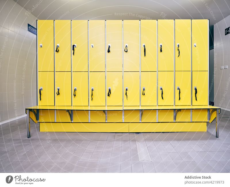 Empty locker room with yellow bench and tiled floor modern style interior creative design corridor empty solitude hallway color key row similar contemporary