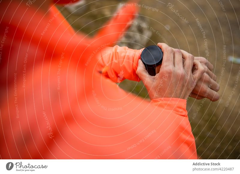 Anonymous sportswoman checking up heart rate on smart watch during workout outdoors heartbeat check up training wellness park using gadget device attentive