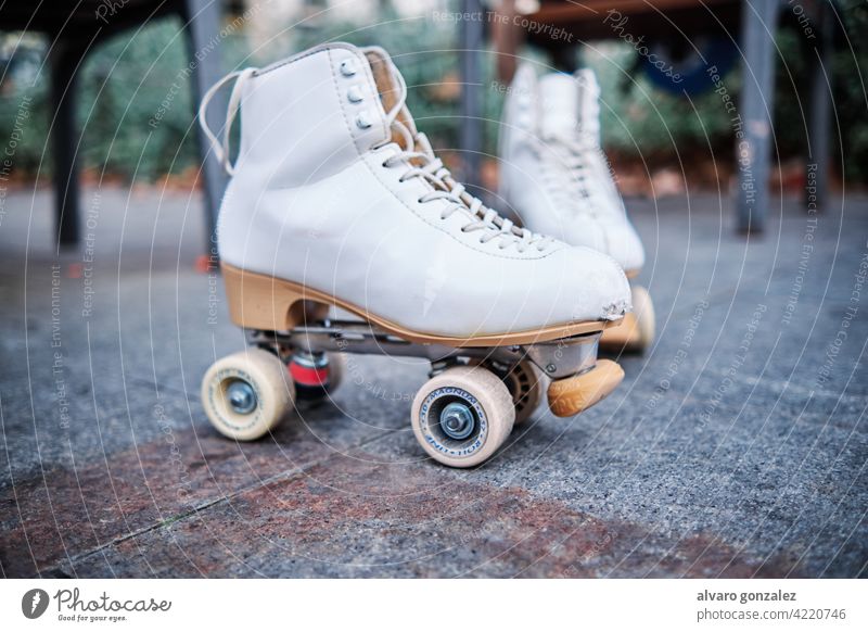 A pair of roller skates on the sidewalk. che exercise hobby sport street outdoors equipment rollerskating recreation roller-skate recreational active leisure
