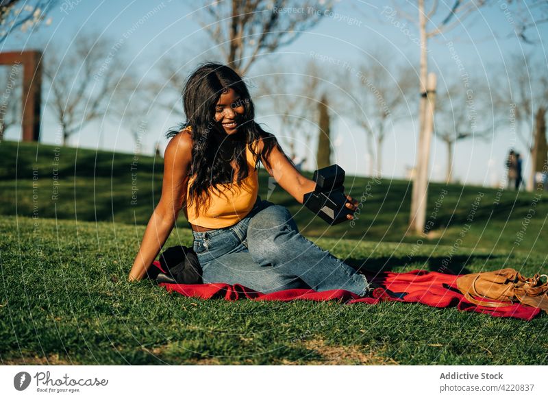 Smiling black woman taking selfie on instant camera in garden self portrait retro park smile memory vintage female african american ethnic moment photo camera