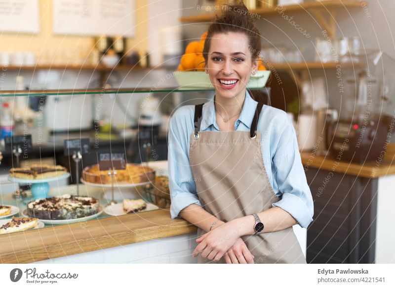 Young woman working in coffee shop people young adult casual attractive female smiling happy indoors Caucasian toothy enjoying cafe restaurant apron business