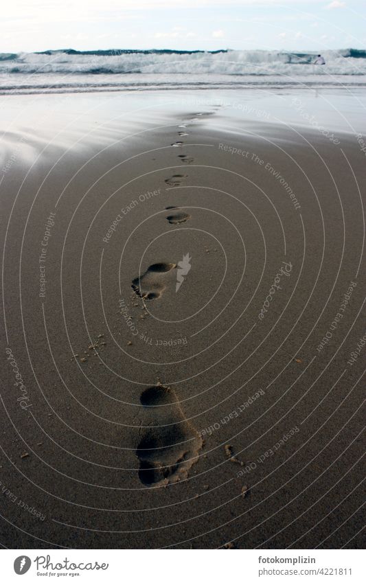 Footprints in the sand on the beach footprints Tracks Pedestrian Sand Vacation & Travel Relaxation meditative Beach Ocean Water Sandy beach Barefoot Waves