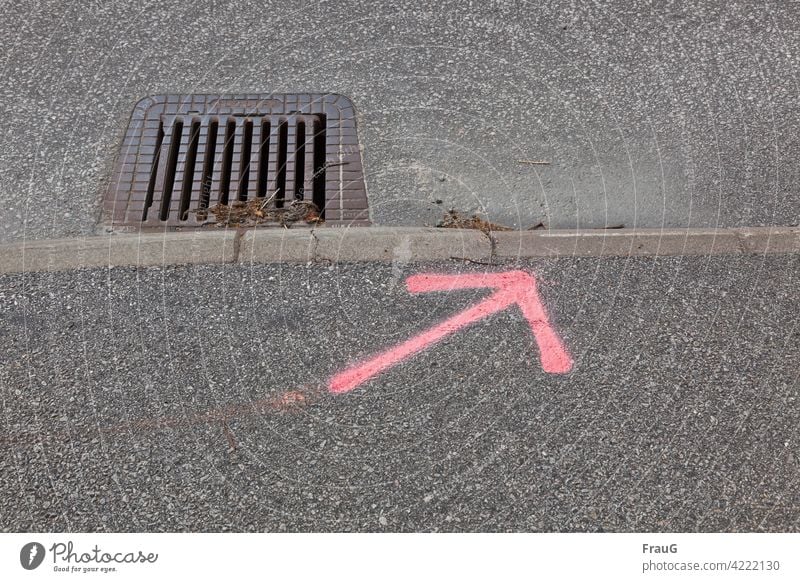 unnecessary | the water does not follow the arrow... Street Traffic infrastructure Asphalt Pavement Curbside curb slop Drainage Arrow Pink Direction Gray