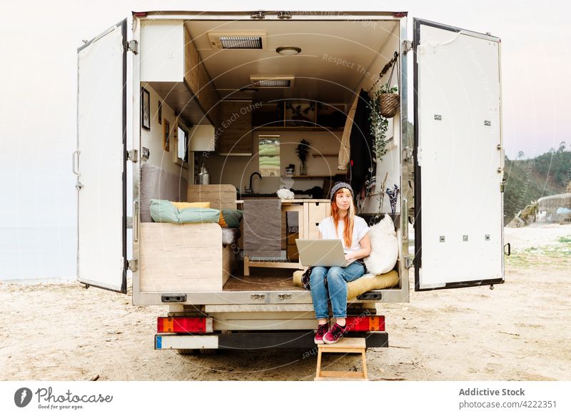 Smiling traveling woman using laptop van smile traveler female hipster cheerful delight enjoy happy talk positive device gadget vacation truck car automobile
