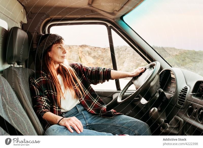 Woman sitting in van in mountains traveler woman truck hipster trip driver parked female vehicle transport smile freedom holiday vacation enjoy seat carefree