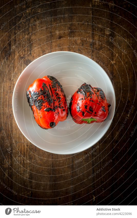 Tasty grilled peppers in bowl on wooden surface vegetable healthy food natural organic tasty whole aroma rustic style material ceramic round shape vegetarian