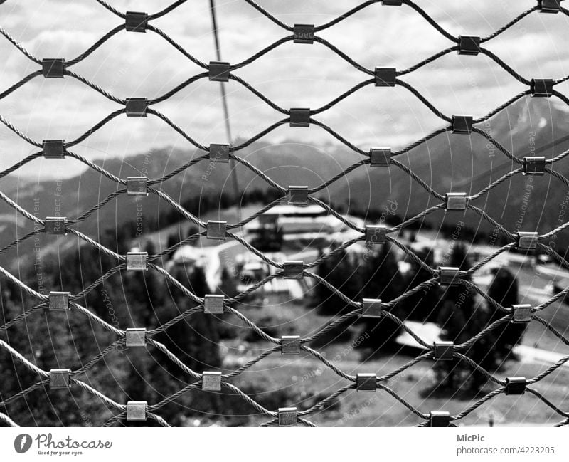behind bars Fence do not jump onlooker Grating latticed Wire netting fence meshes Rope Cable car gondola Vantage point Safety Barrier Protection Exterior shot
